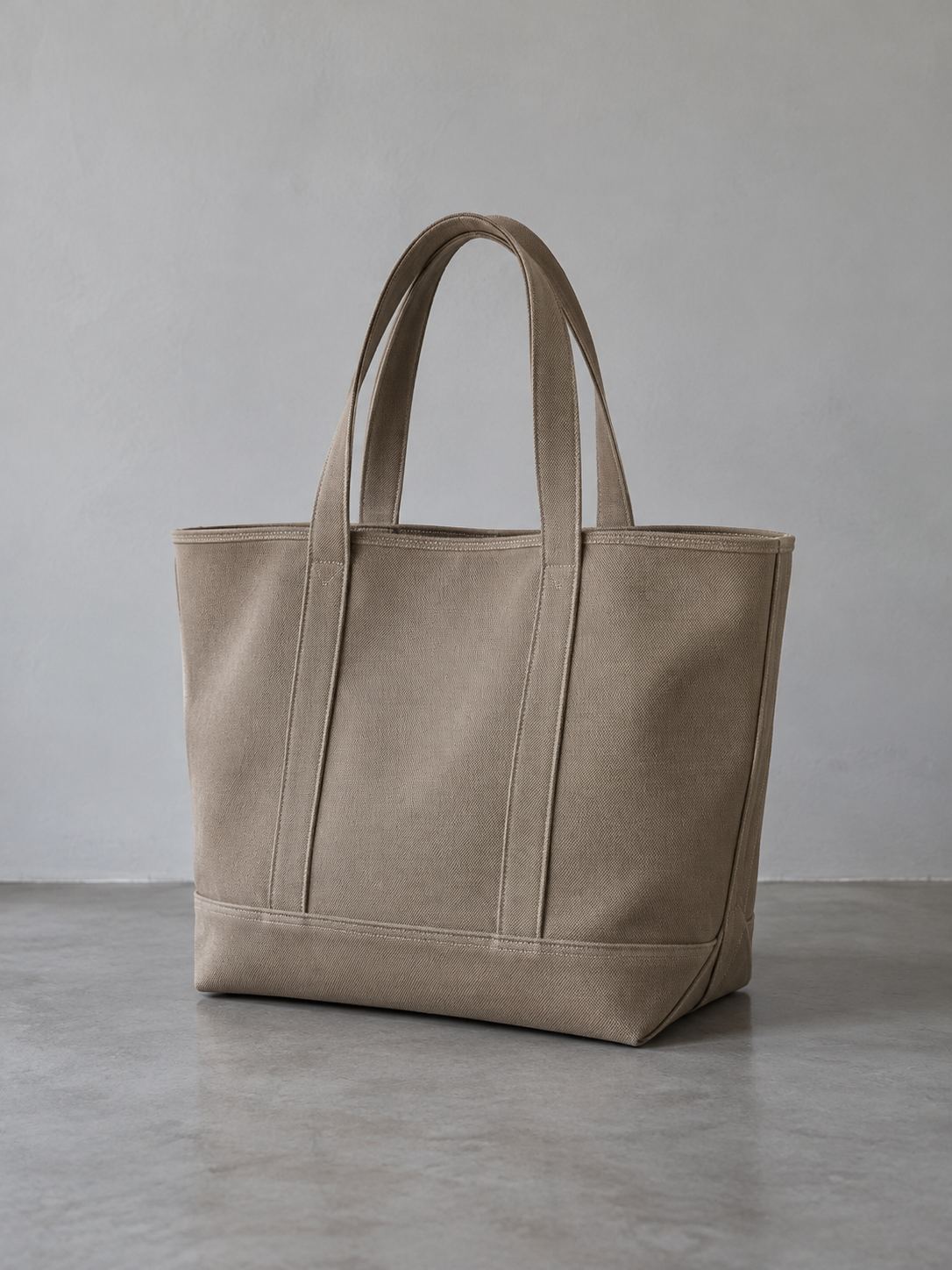 An unbranded canvas tote against a gray wall
