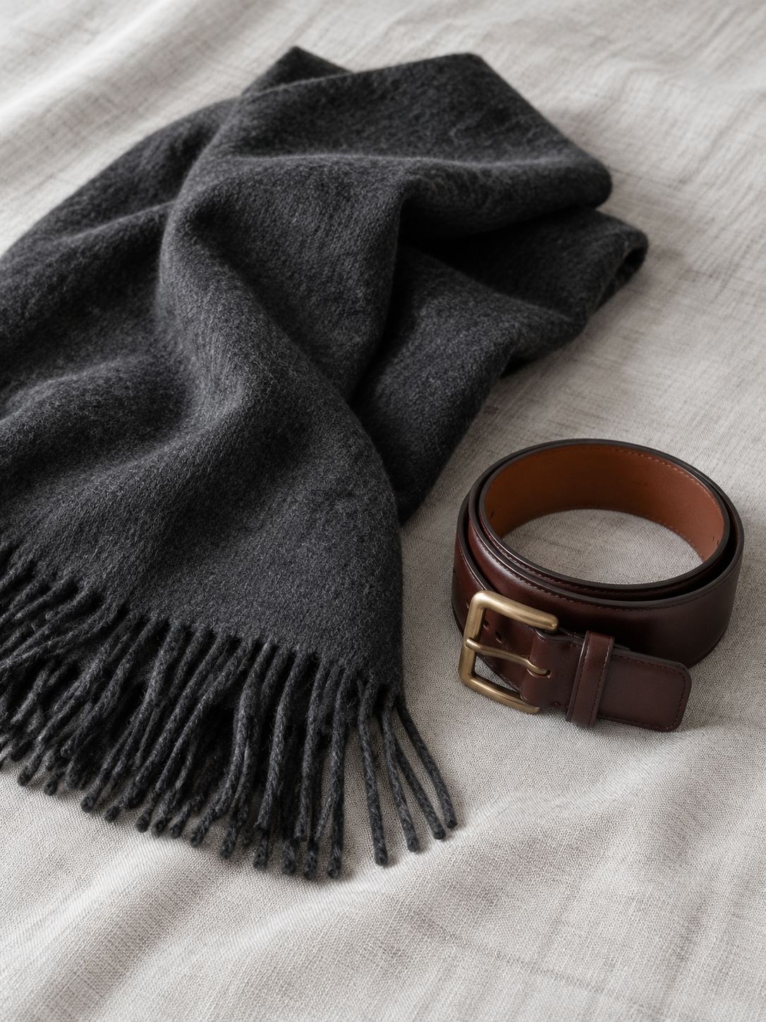 A charcoal scarf and a leather belt